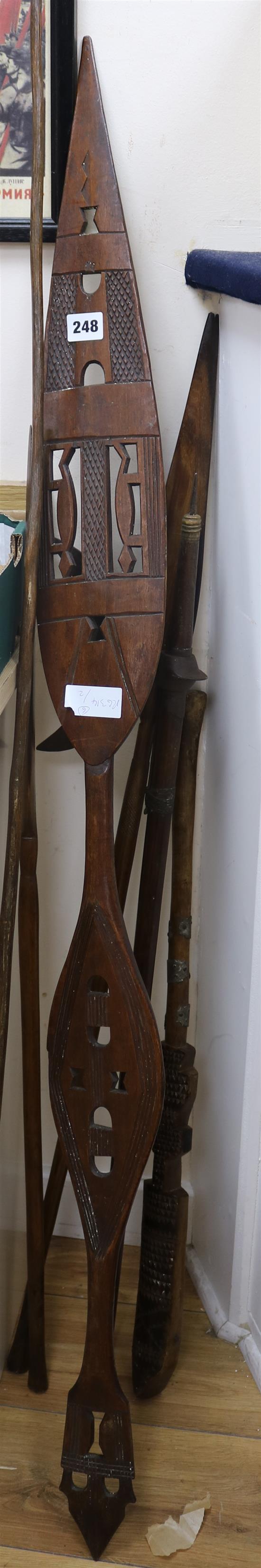 A crescent headed axe and five wooden spears/clubs